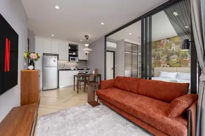 a living room with a couch and a kitchen at Evora 1BR Suite — The Title Legendary BangTao in Bang Tao Beach