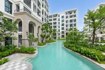 an apartment courtyard with blue water and buildings at Evora 1BR Suite — The Title Legendary BangTao in Bang Tao Beach