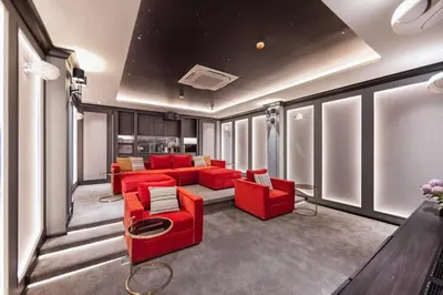 a living room with red furniture and windows at Evora 1BR Suite — The Title Legendary BangTao in Bang Tao Beach