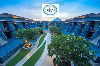 an overhead view of the courtyard of a hotel with trees at The Phu Beach Hotel - SHA Plus in Ao Nang Beach