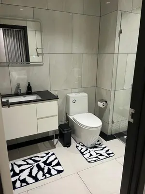 a bathroom with a toilet and a sink and a mirror at The Title Legendary Bang-Tao access to the pool in Bang Tao Beach