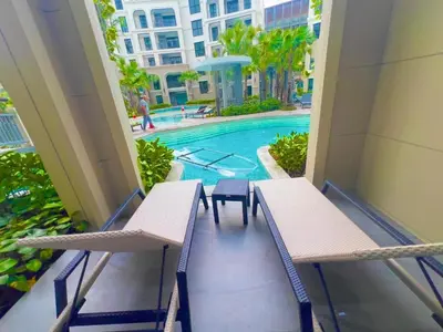 a balcony with two chairs and a swimming pool at The Title Legendary Bang-Tao access to the pool in Bang Tao Beach