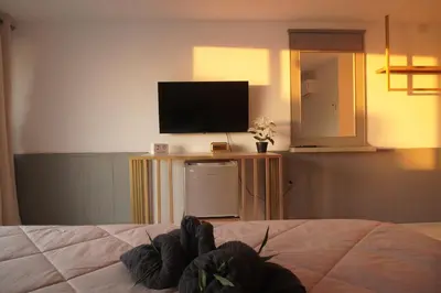 a bedroom with a bed with a tv and a televisionictericter at Residy Hideaway in Patong Beach