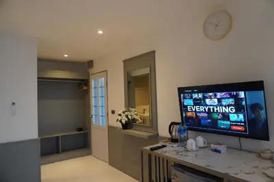 a living room with a flat screen tv on a wall at Residy Hideaway in Patong Beach