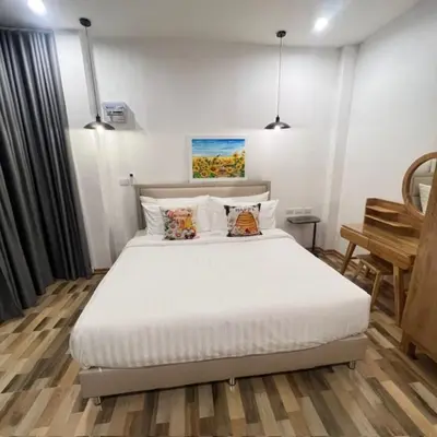 a bedroom with a large white bed in a room at Stingless Villa in Ban Ket Ho