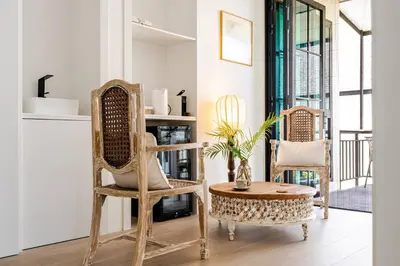 a living room with two chairs and a table at Sarah Place Private Tropical Villa in Ban Pak Lak