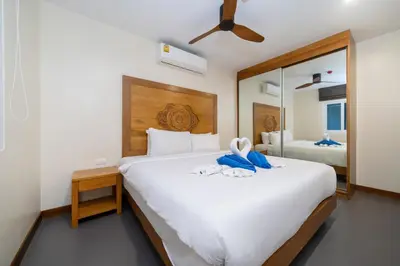 a bedroom with a large white bed with a mirror at Convenient apartment at Karon Butterfly by Lofty in Karon Beach