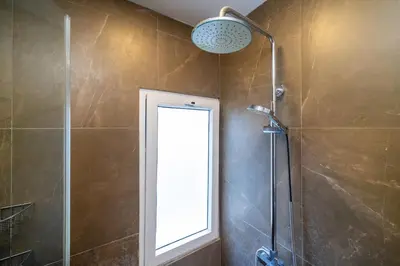 a bathroom with a shower with a window and a mirror at Convenient apartment at Karon Butterfly by Lofty in Karon Beach