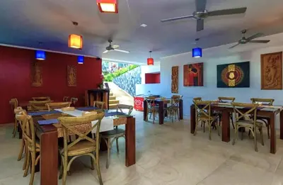 a dining room with wooden tables and chairs at Convenient apartment at Karon Butterfly by Lofty in Karon Beach