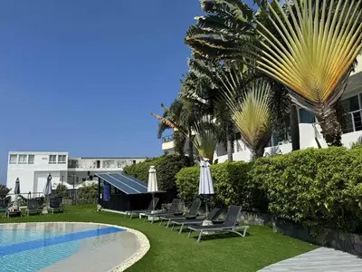 a group of lounge chairs next to a swimming pool at Convenient apartment at Karon Butterfly by Lofty in Karon Beach