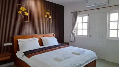 a bedroom with a large bed with two towels on it at Gentle Guesthouse in Patong Beach