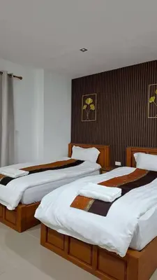 two beds in a hotel room at Gentle Guesthouse in Patong Beach
