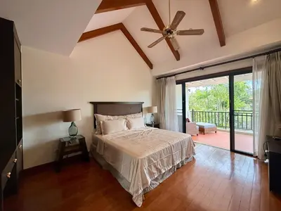 a bedroom with a bed and a ceiling fan at Tropical Thai style 4 bedroom pool villa in Laguna Phuket
