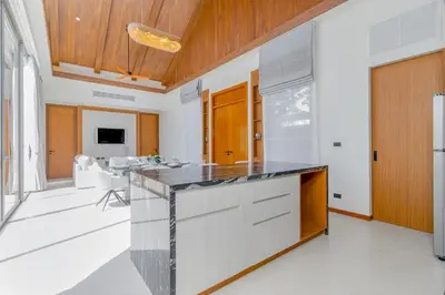 a kitchen with a large island with a counter top at V277 Famous Ozone Resort Calm Area Near Beach in Thalang