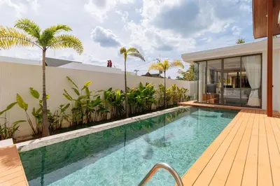 a swimming pool next to a building with a house at V277 Famous Ozone Resort Calm Area Near Beach in Thalang