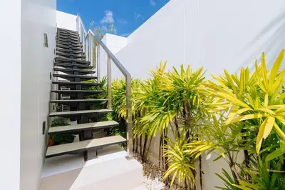 a staircase leading up to a house with plants at V277 Famous Ozone Resort Calm Area Near Beach in Thalang