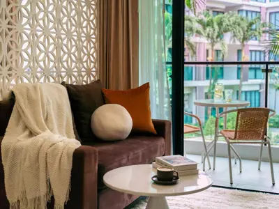 a living room with a couch and a table at Cozy 1 Bdr Royal Lee Nayang beach in Ban Bo Han