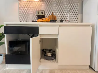 a kitchen with a white counter and a microwave at Cozy 1 Bdr Royal Lee Nayang beach in Ban Bo Han