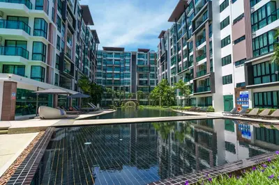 a swimming pool in the middle of some buildings at Cozy 1 Bdr Royal Lee Nayang beach in Ban Bo Han