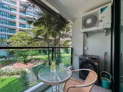 a balcony with a table and chairs and a window at Cozy 1 Bdr Royal Lee Nayang beach in Ban Bo Han