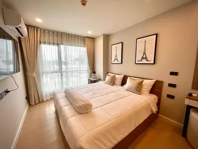 a bedroom with a large bed with a large window at Family Space Condo 2 Bdr BangTao in Ban Thalat Choeng Thale