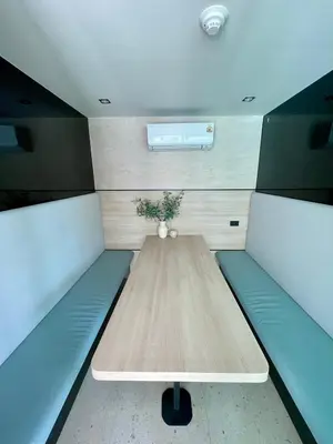 a small room with a table and benches in it at Family Space Condo 2 Bdr BangTao in Ban Thalat Choeng Thale