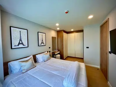a bedroom with a large white bed with the eiffel tower at Family Space Condo 2 Bdr BangTao in Ban Thalat Choeng Thale