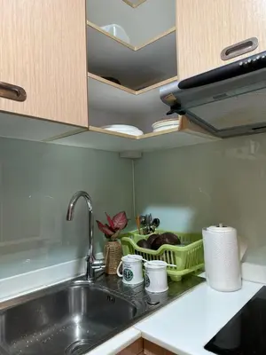 a kitchen counter with a sink and a dish rack at Cozy Condo with full kitchen Patong in Patong Beach