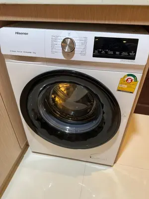 a washing machine sitting on top of a counter at Cozy Condo with full kitchen Patong in Patong Beach