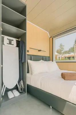 a small bedroom with a bed and a window at Apple House Bangtao Pool, Terrace & Breakfast in Ban Lum Fuang