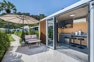 an open kitchen and living area of a tiny house at Beachside Apple House Pool & Terrace in Bangtao in Ban Lum Fuang