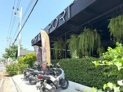 a row of motorcycles parked in front of a building at Apple House Phuket Pool, Terrace, Breakfast, Beach in Ban Lum Fuang