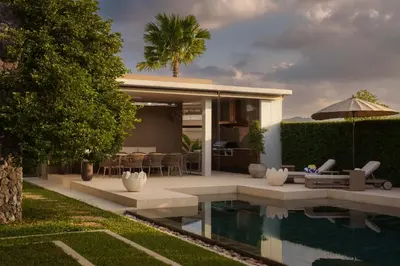 a villa with a swimming pool and a house at Luxury Botanica Villa in Ban Phru Champa