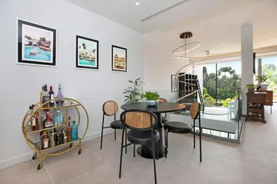 a dining room with a table and chairs in a room at Peaceful Penthouse @ Lotus Gardens Layan Beach in Layan Beach