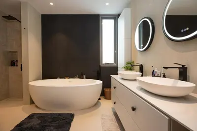 a bathroom with two sinks and two mirrors at Peaceful Penthouse @ Lotus Gardens Layan Beach in Layan Beach