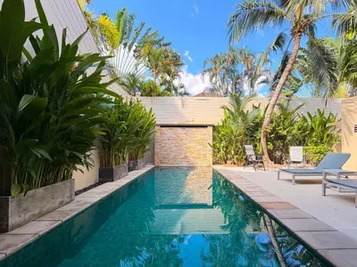 a swimming pool in a villa with palm trees at The Residence Resort Pool Villa 2 Bedrooms and 2 Bathrooms in Ban Thalat Choeng Thale