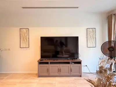 a living room with a flat screen tv on a cabinet at The Residence Resort Pool Villa 2 Bedrooms and 2 Bathrooms in Ban Thalat Choeng Thale