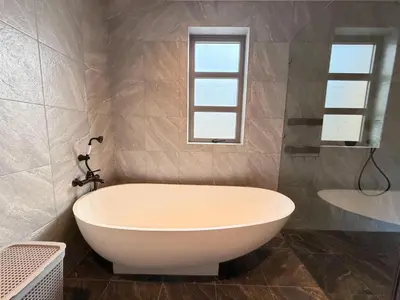 a white bath tub in a bathroom with a window at The Residence Resort Pool Villa 2 Bedrooms and 2 Bathrooms in Ban Thalat Choeng Thale