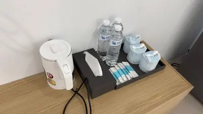 a table with water bottles on top of it at Airport Stay Phuket Zz in Nai Yang Beach
