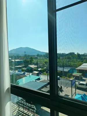 a view of a city from a window at Airport Stay Phuket Zz in Nai Yang Beach