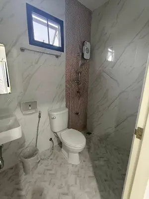 a bathroom with a toilet and a sink and a window at Airport Stay Phuket Zz in Nai Yang Beach