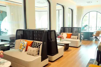 a living room with two chairs and a table at The Title Legendary by TVC company in Bang Tao Beach