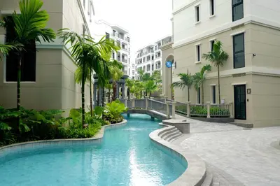 a swimming pool in the middle of a street with buildings at The Title Legendary by TVC company in Bang Tao Beach