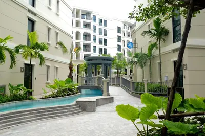 a building with a fountain in the middle of a courtyard at The Title Legendary by TVC company in Bang Tao Beach