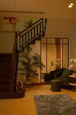 a living room with a staircase and a plant at Bursuai - Lake view family pool Laguna Village in Ban Thalat Choeng Thale