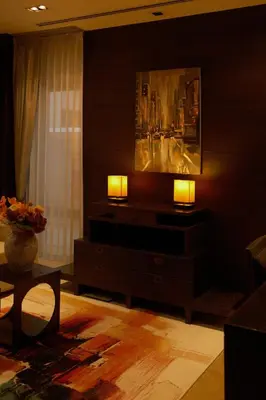 a living room with two lamps and a painting on the wall at Bursuai - Lake view family pool Laguna Village in Ban Thalat Choeng Thale