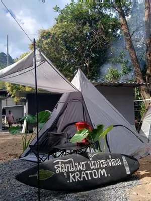 a tent and a kayak sitting on the ground at Kalaland Patong camp in Patong Beach
