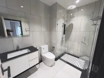 a bathroom with a shower and a toilet and a sink at title legendary in Bang Tao Beach