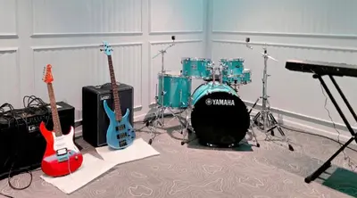 a room with two guitars and a drum set at title legendary in Bang Tao Beach