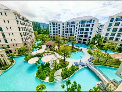 an aerial view of a resort with blue water at title legendary in Bang Tao Beach
